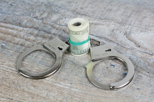 handcuffs and money roll