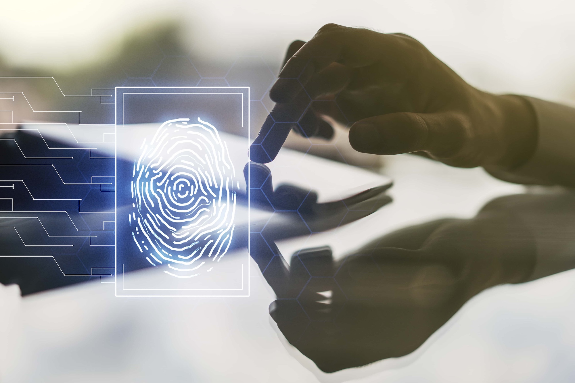 A hand hovers over a tablet screen with a glowing digital fingerprint icon and circuit lines appearing above. The background is blurred, emphasizing the futuristic and technological theme.