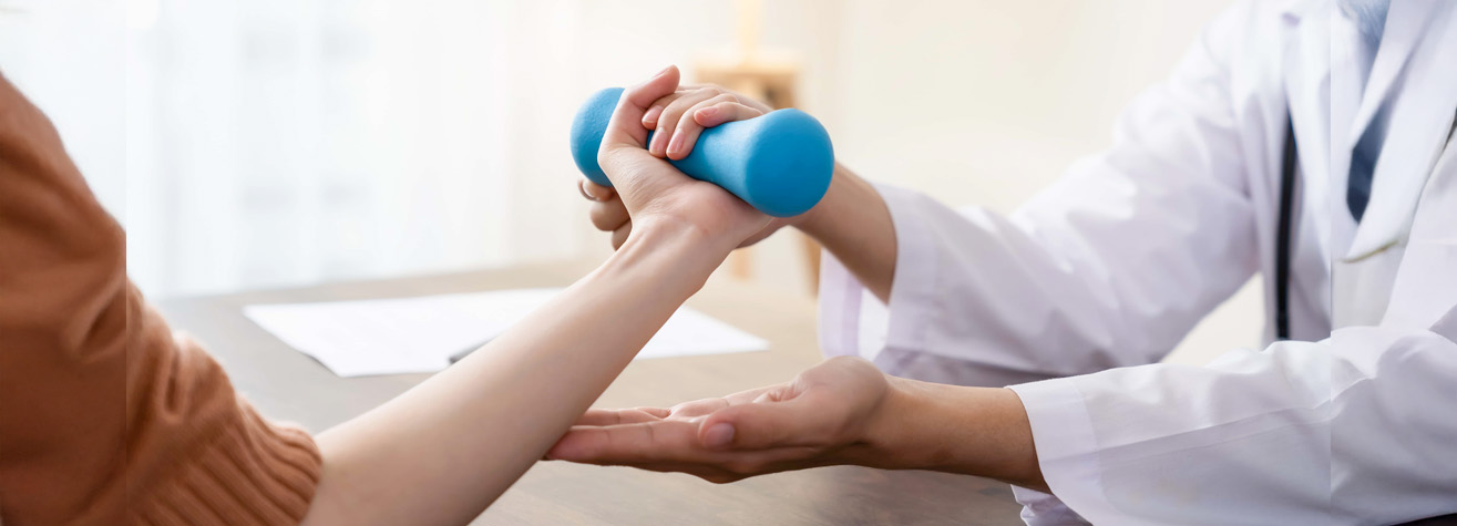 A person in a brown shirt lifts a blue dumbbell with assistance from a professional in a white coat, likely a physical therapist or doctor, during rehab at a clinic—a setting where you might also find guidance from Seabrook Personal Injury Lawyer experts.