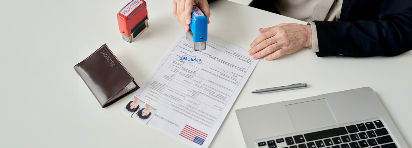A person stamps a document labeled 