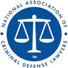 Blue circular logo with a balanced scale in the center. Surrounding the scale, text reads 